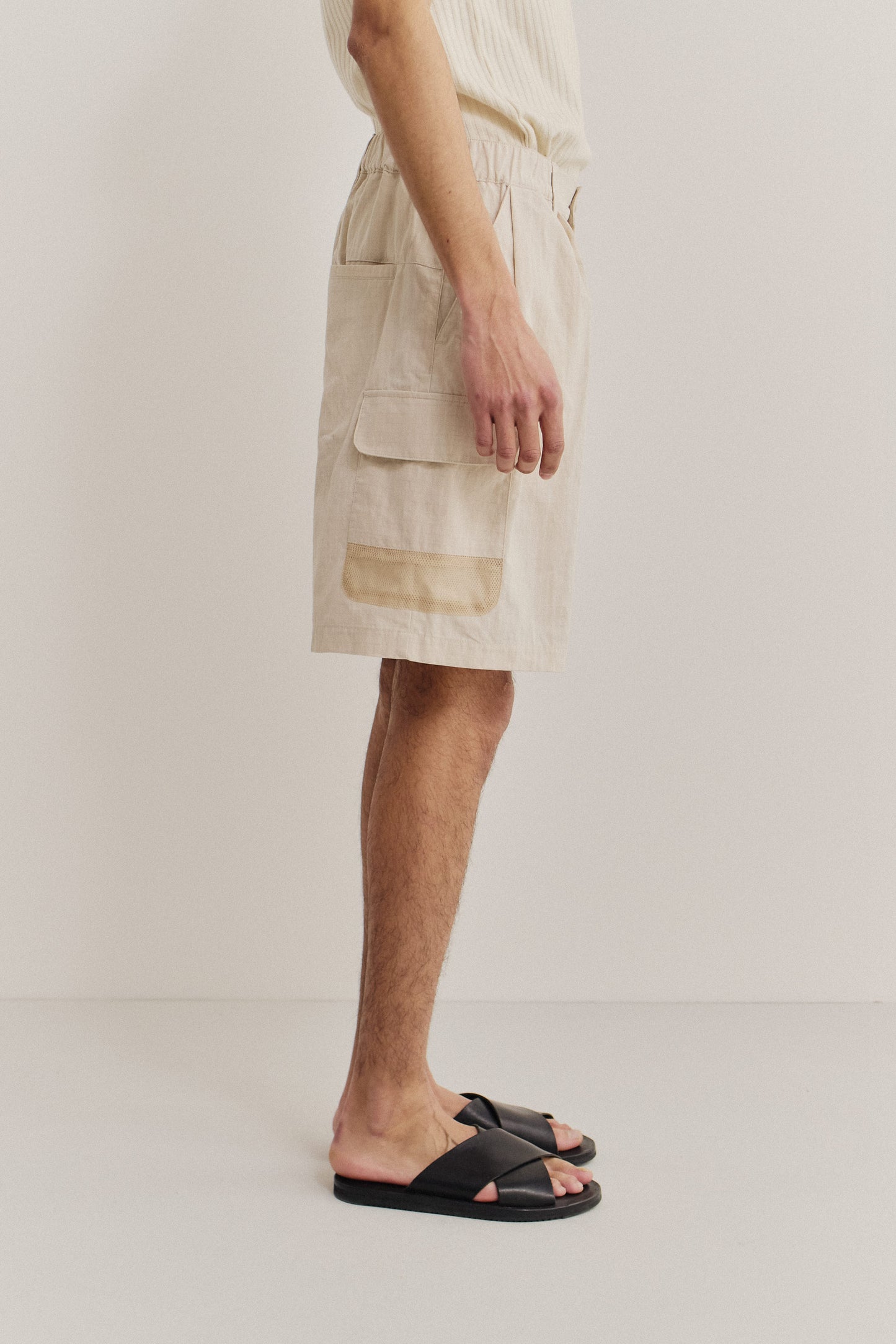 Men's shorts, cotton blend ripstop, waxed finish, beige, with patch pockets and mesh details.