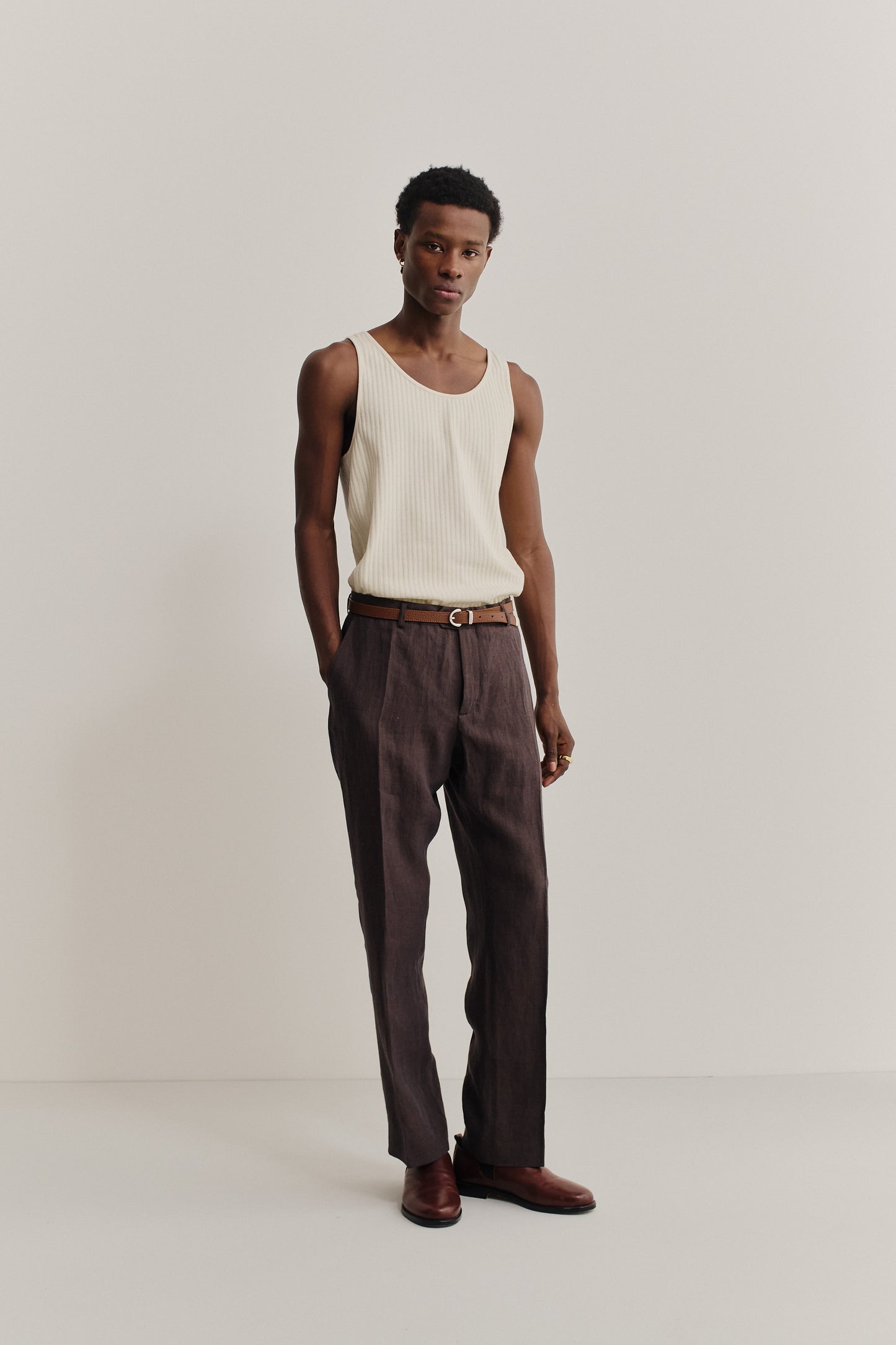 Men's long-pants, 100% linen, dark brown, with a tailored waist, tapered leg, and front pleat.