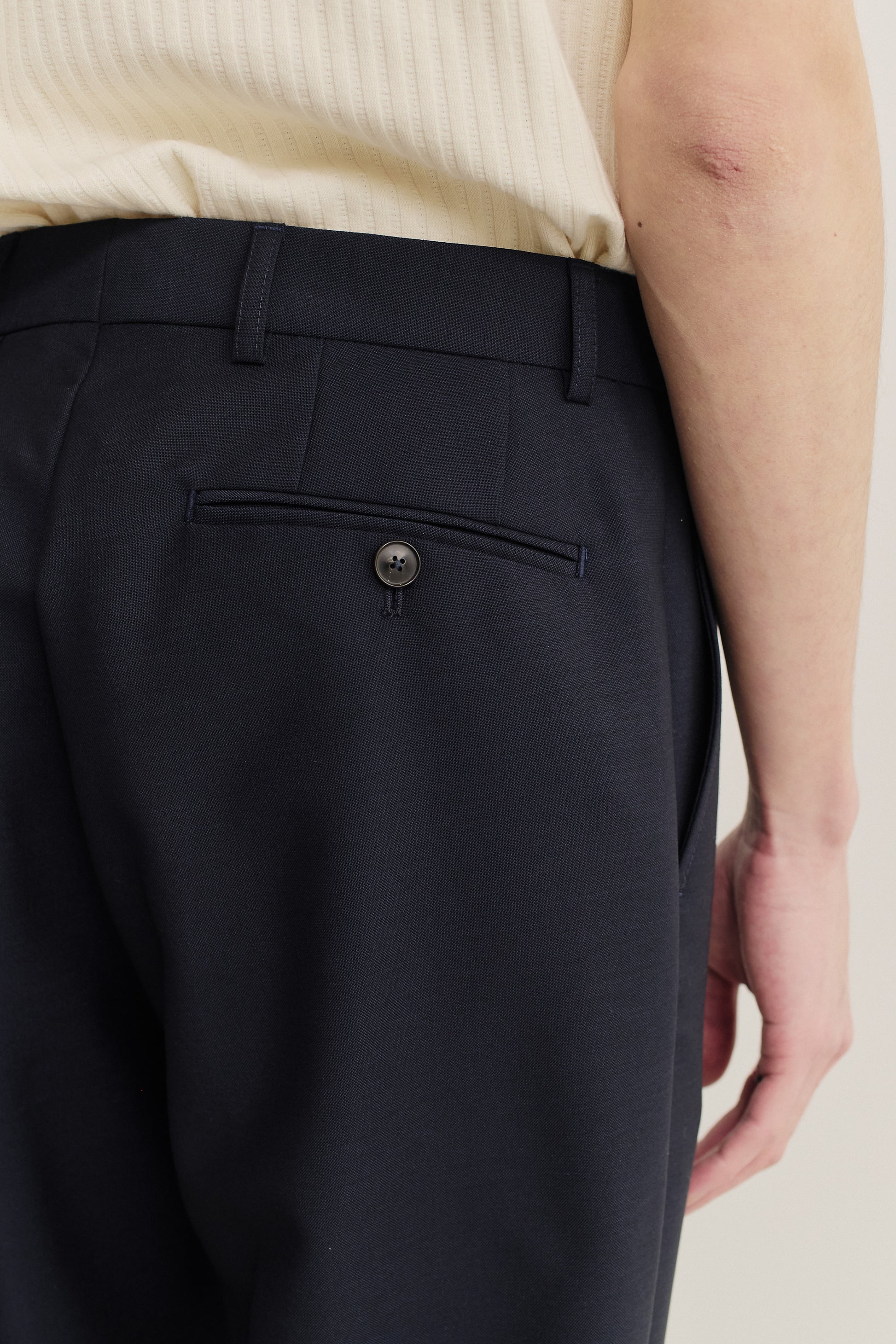 Men's long-pants, virgin wool, dark navy, with buttoned welt back pocket.