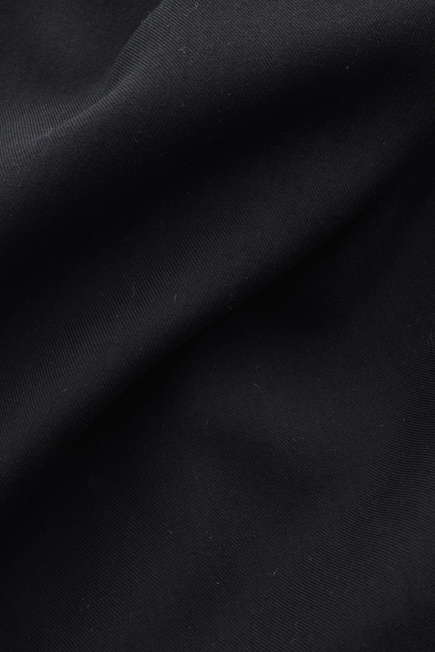 Men's shorts, 100% lyocell heavy twill in soft black, with fluid drape and matte surface.