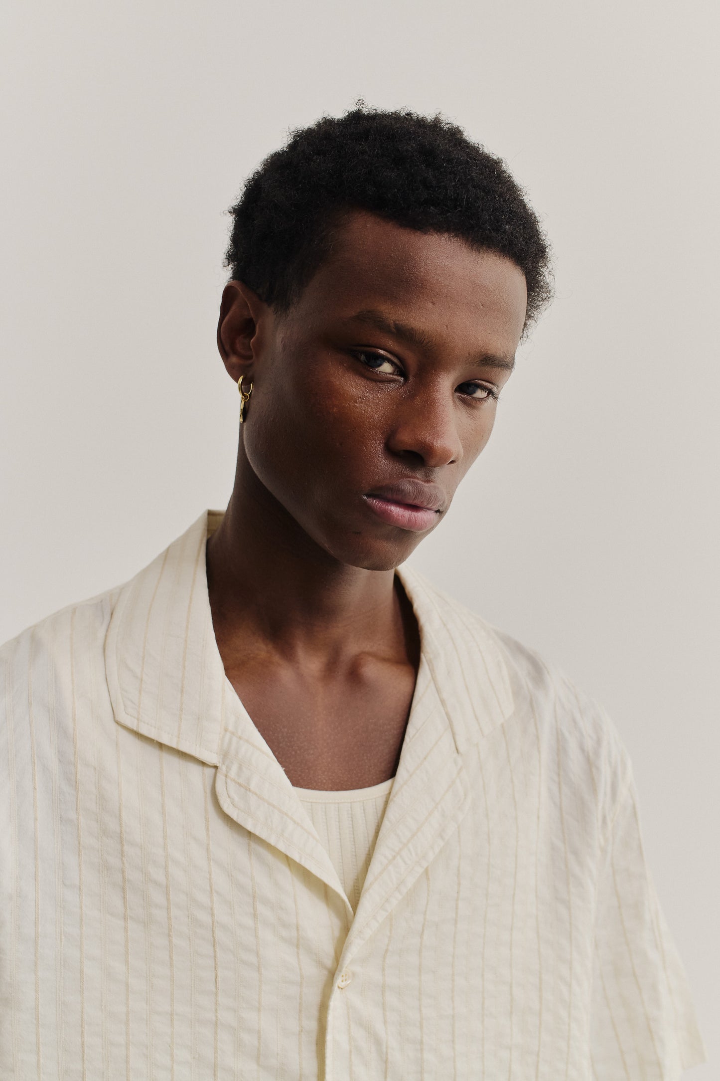 Men's short-sleeved shirt, cotton-silk-linen blend, washed, light cream with subtle stripes.