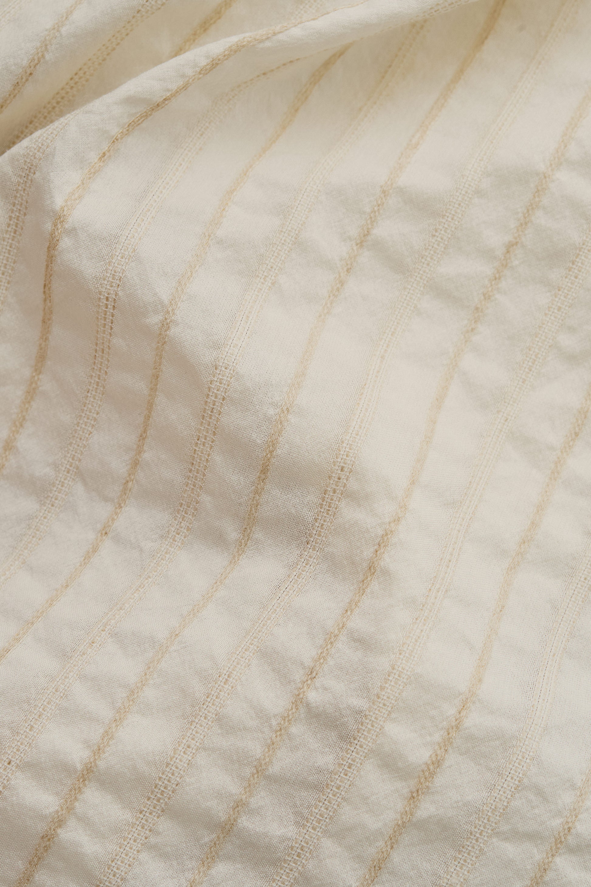 Men's short-sleeved shirt, cotton-silk-linen blend, washed finish, cream with irregular beige stripes.
