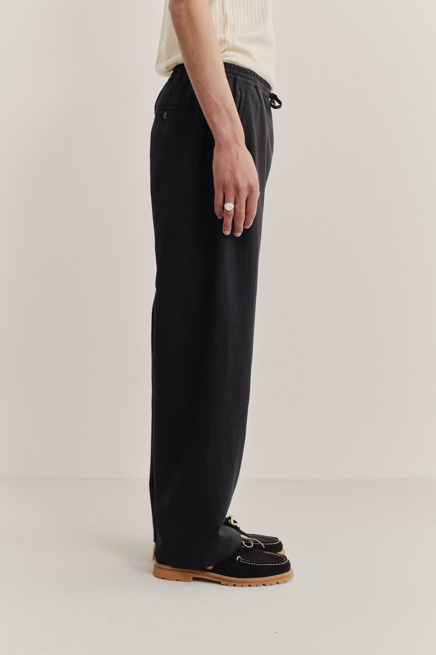 Men's long-pants, worsted wool and linen blend, black, wide straight fit with elastic waist and welt pockets.