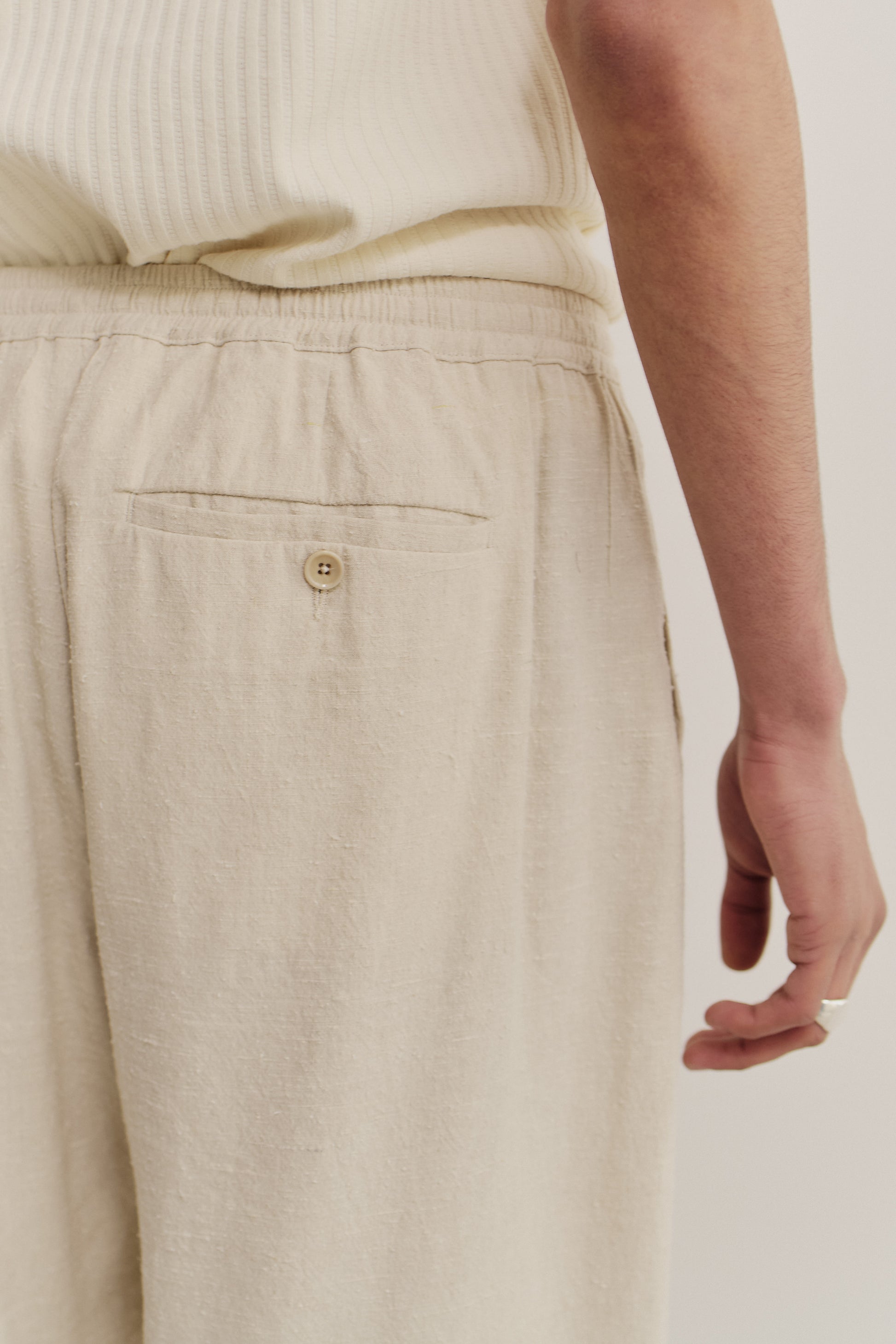 Unisex long-pants, linen silk blend, naturally textured, undyed, unbleached, with elastic waist and buttoned back pocket.