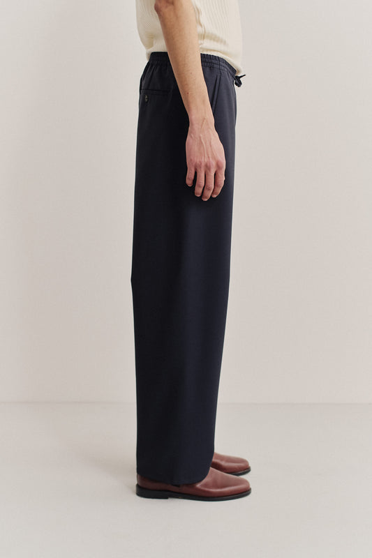 Unisex long-pants, 100% virgin wool, dark navy, wide straight fit, elasticated waistband.