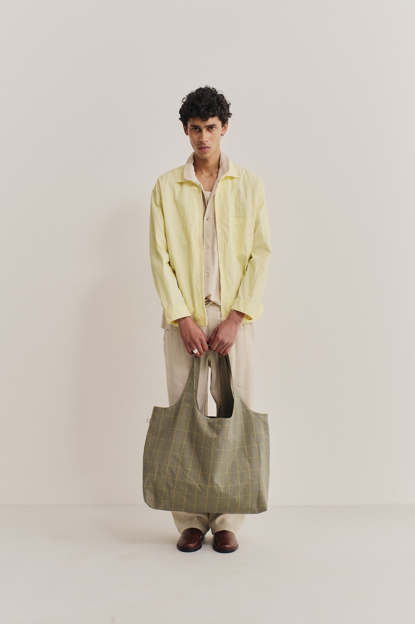 Women's accessories cotton Thika Bag, checkered houndstooth in navy, green, and yellow on beige.