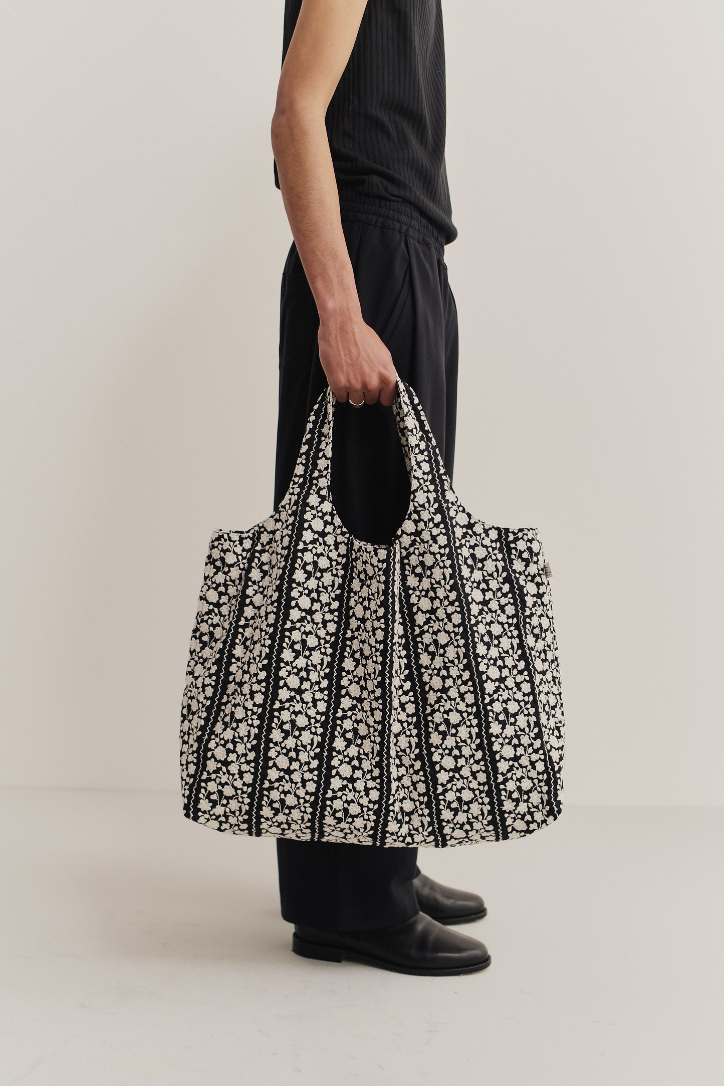Women's accessories bag, cotton, black with white embroidered flower blocks and wavy lines.