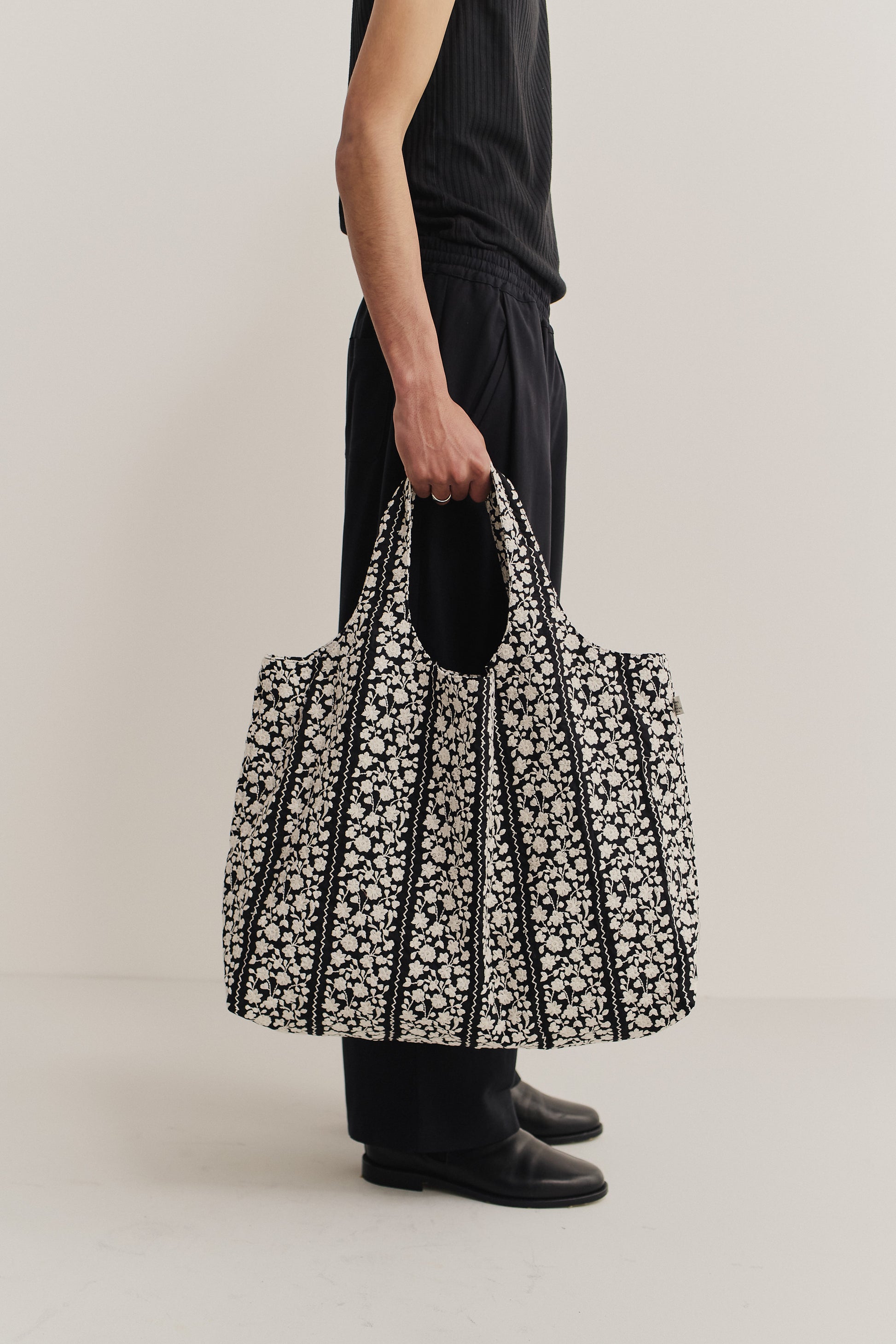 Women's accessories bag, cotton, black with white embroidered flower blocks and wavy lines.
