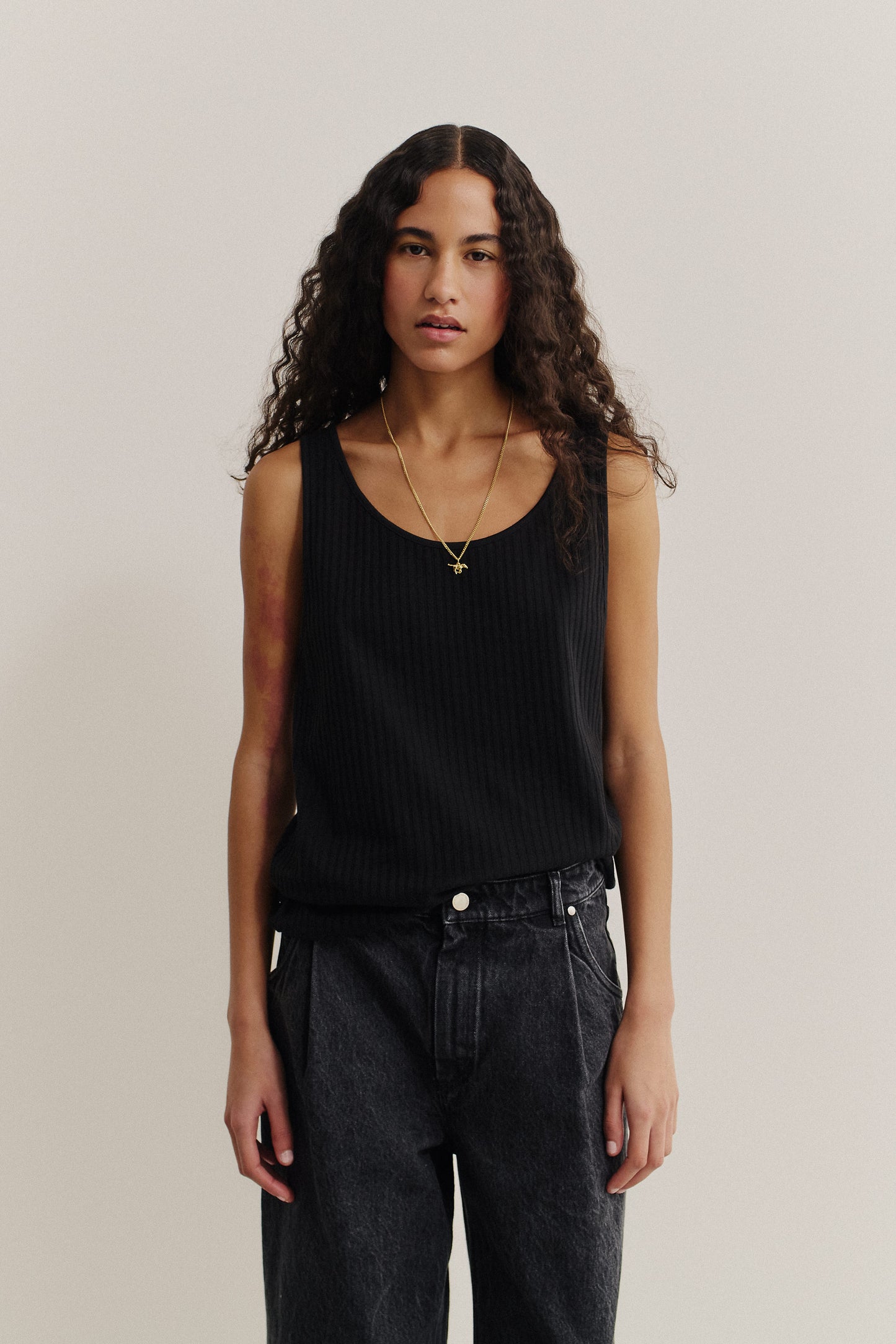 Women's jersey tanktop, cotton mix, garment dyed black, with a wide scooped neckline and rib structure.
