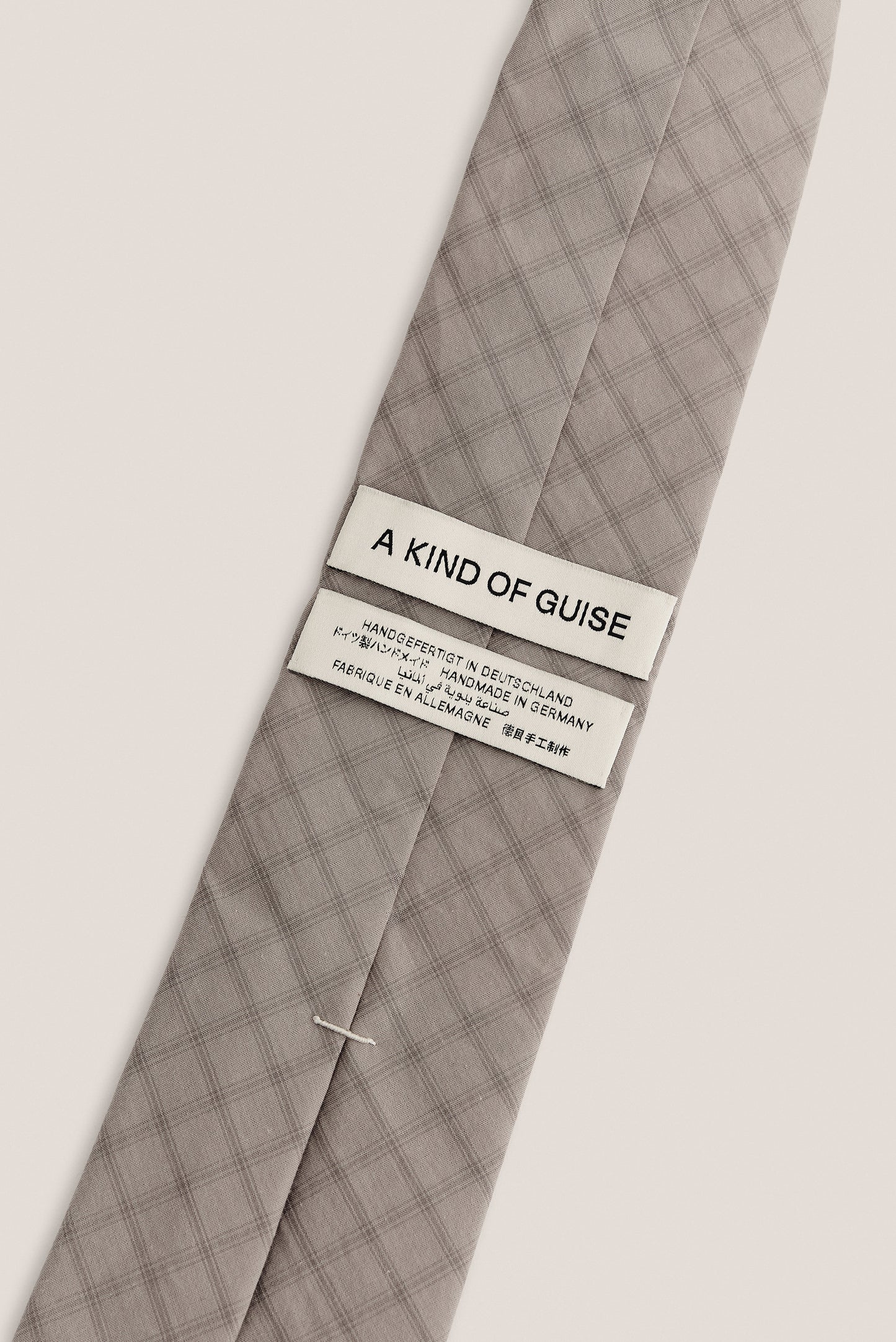 Men's accessories tie, 100% organic cotton, light grey with dark grey squared check pattern.