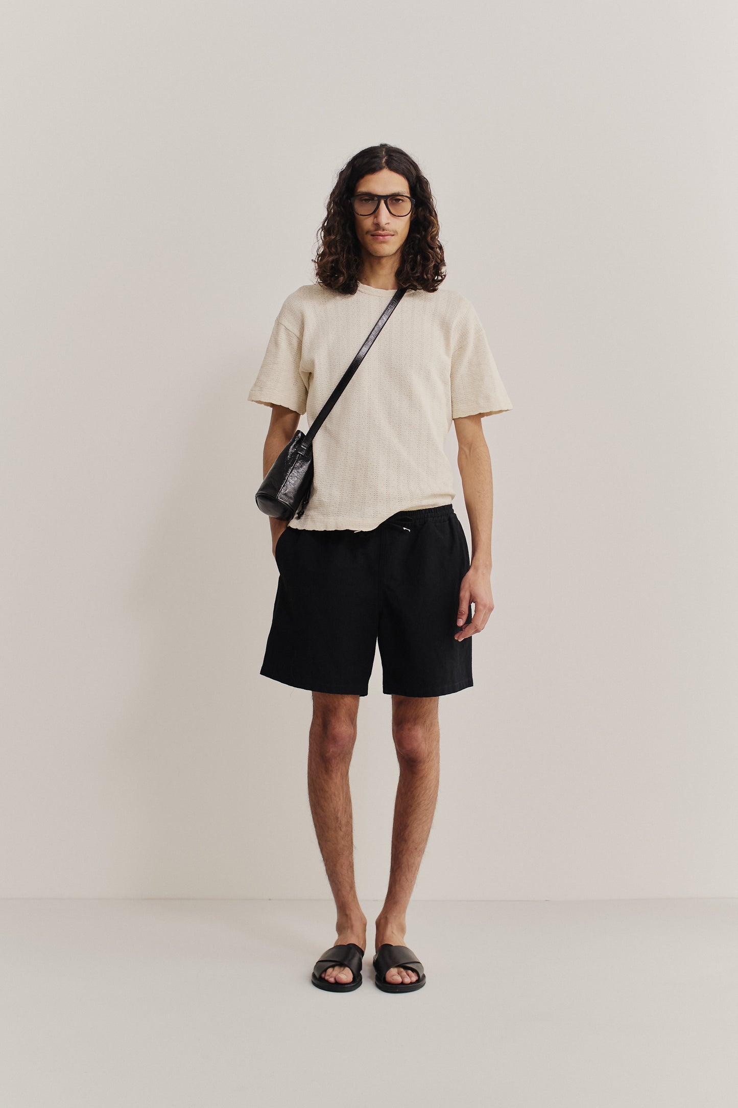 Men's shorts, worsted wool and linen blend, black, with adjustable waistband and side pockets.