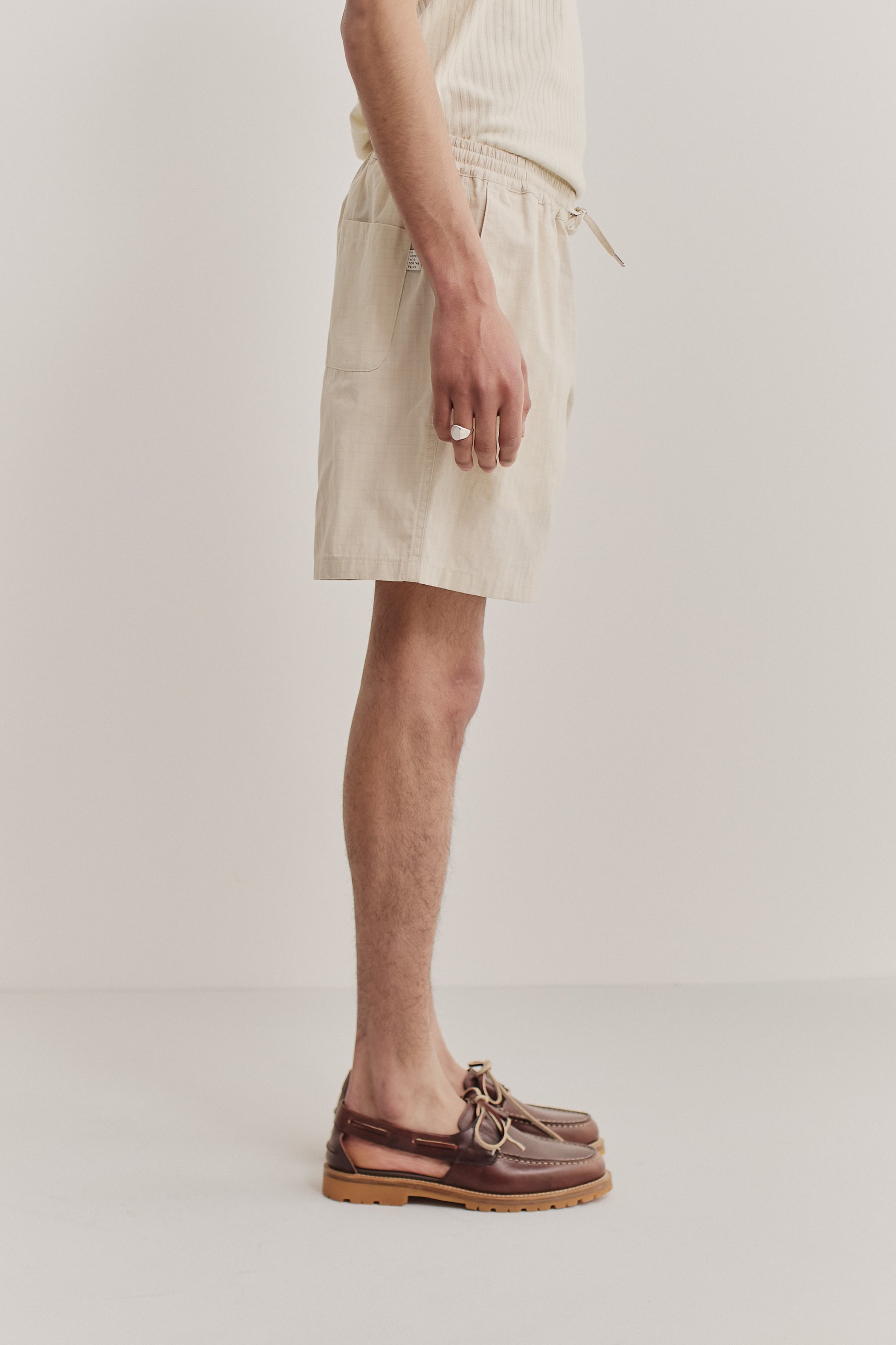 Men's shorts, cotton blend ripstop, waxed finish, light beige, with side pockets and drawstring waist.