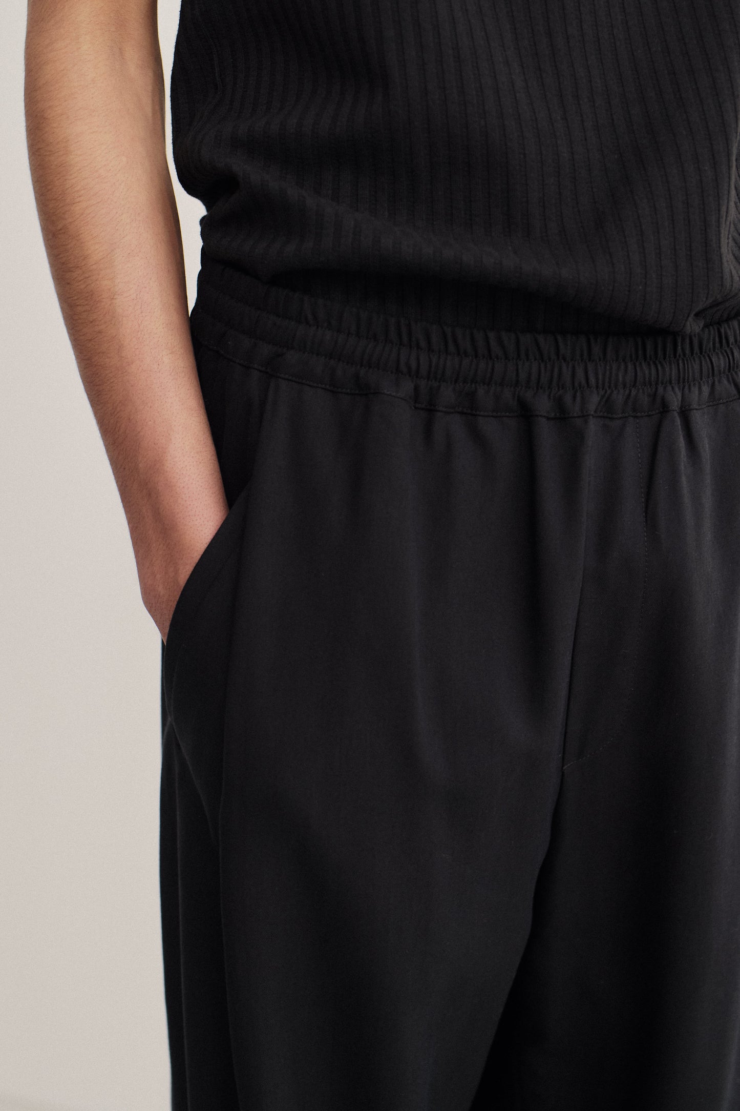 Men's long pants, lyocell heavy twill, black, elastic waist, wide leg, front pleat, slanted welt pockets.
