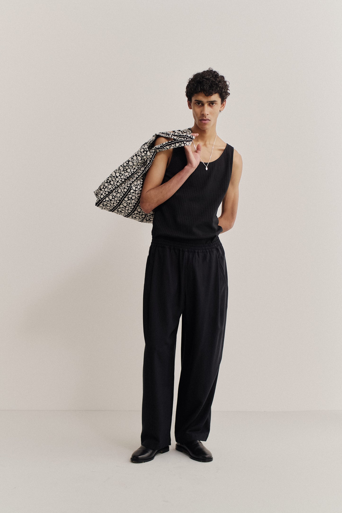 Men's long-pants, lyocell heavy twill, black, with elastic waist, wide leg, and front pleats.