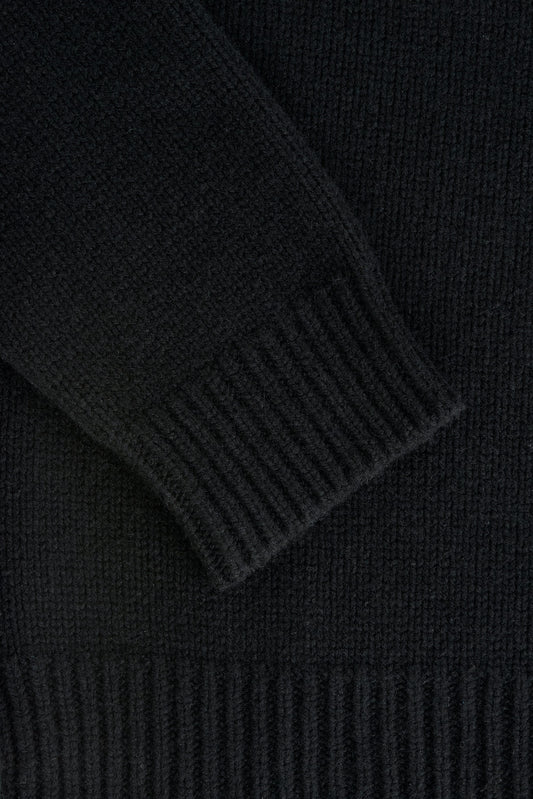 Men's knit pullover, black merino wool-cashmere blend, with ribbed cuff and hem details.