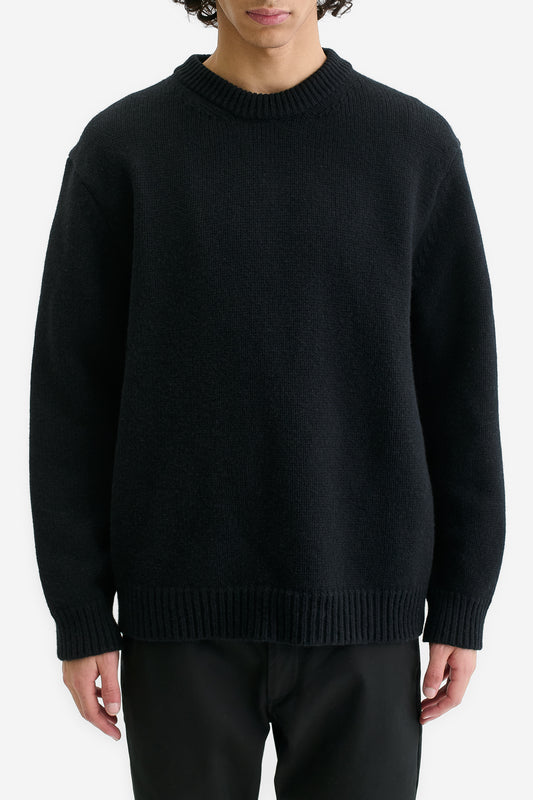 Men's knit pullover, black merino wool-cashmere blend, relaxed fit, rib-knit neck, cuffs, and hem.