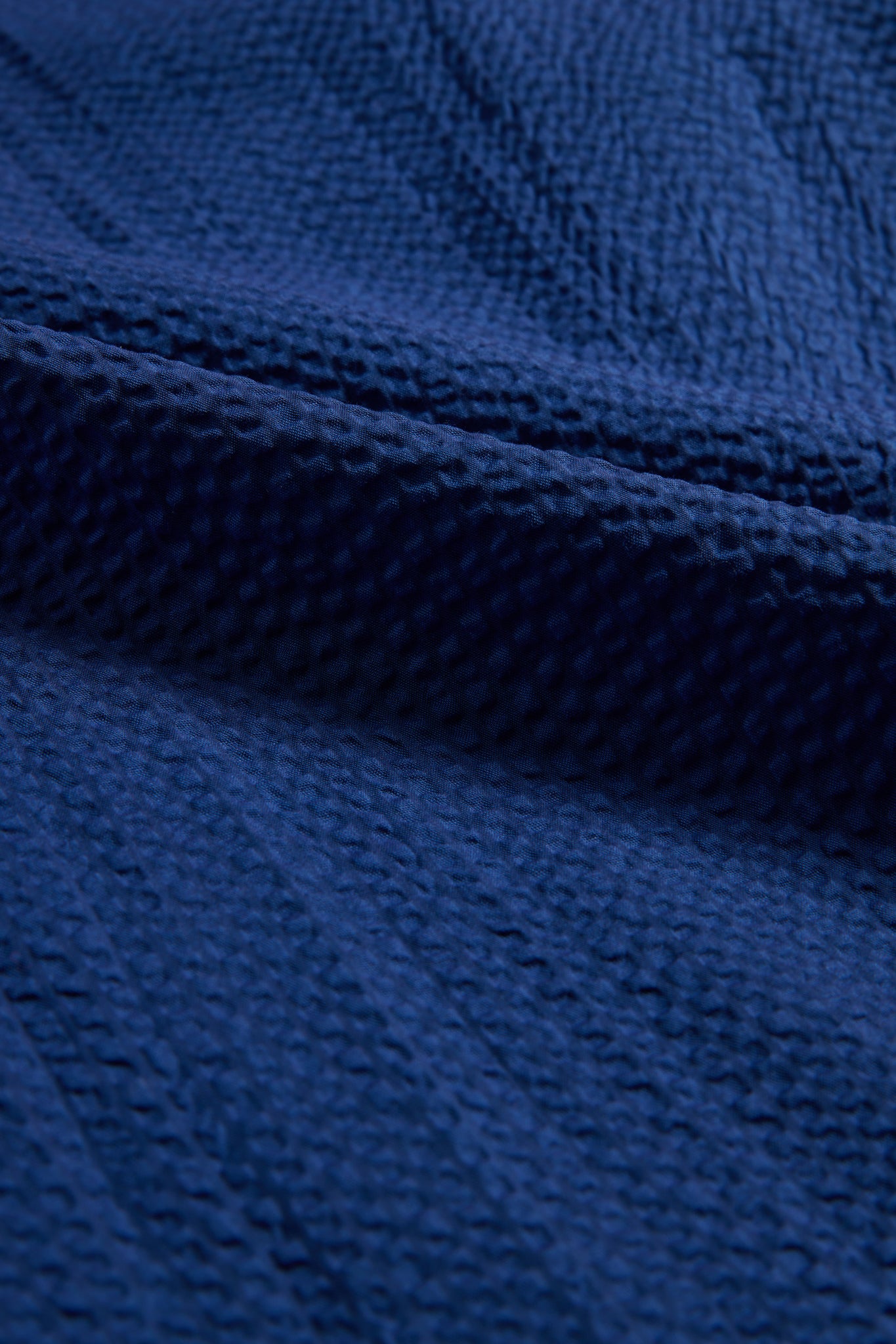Duvet cover, 100% organic cotton seersucker, blue hour, with subtle texture and folds.