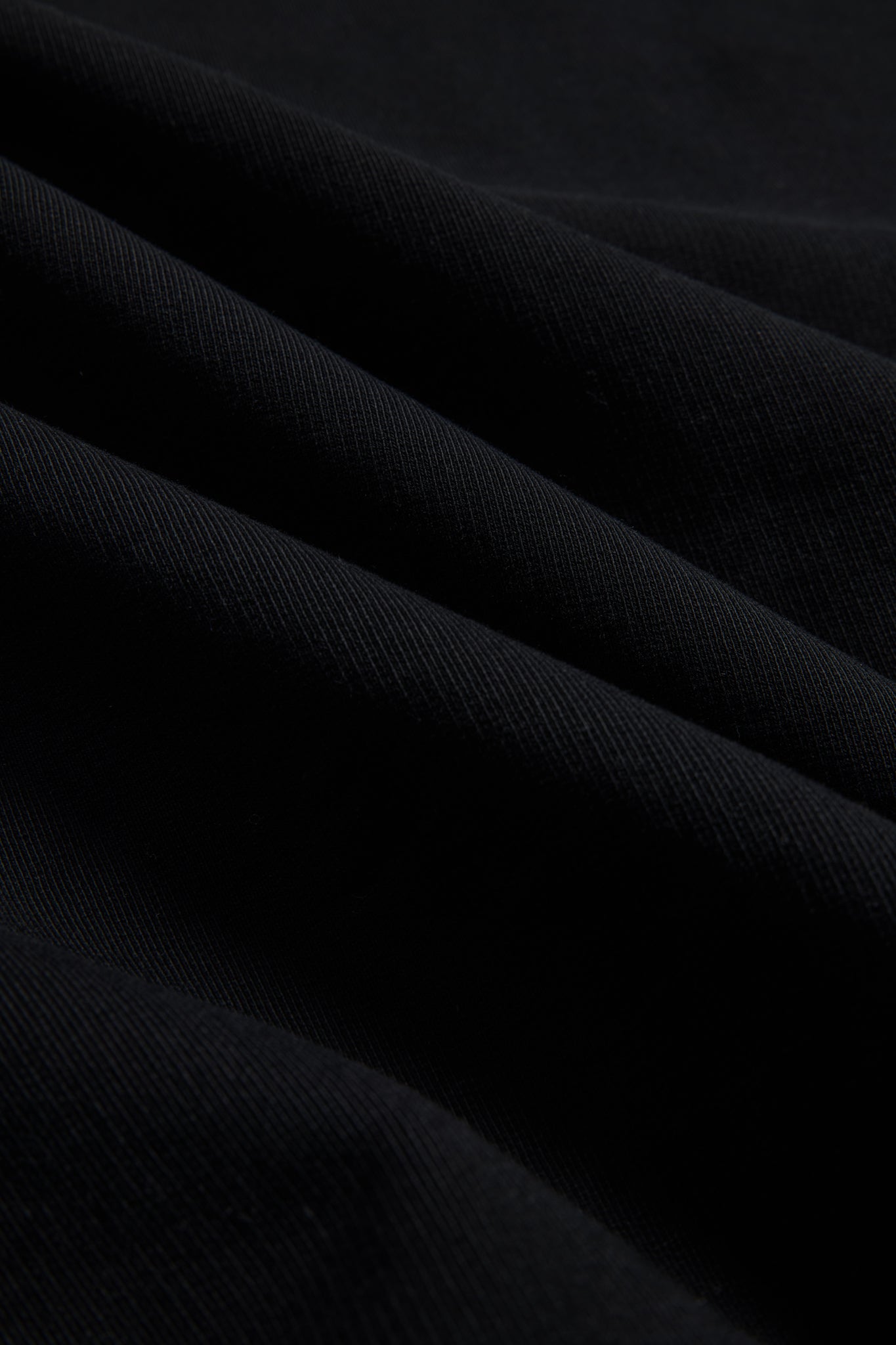 Unisex knit sweater, black 100% organic cotton, pre-washed heavy jersey fabric with subtle folds.